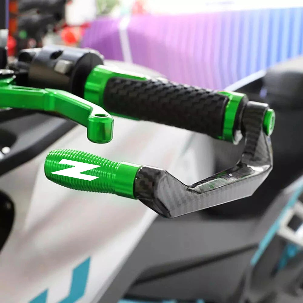 Close-up of a motorcycle lever and handguard protector kit with green and black grips and silver components.