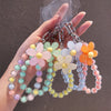 A hand holds a phone anti-loss lanyard featuring round beads in pastel colors like pink, yellow, green, and blue.
