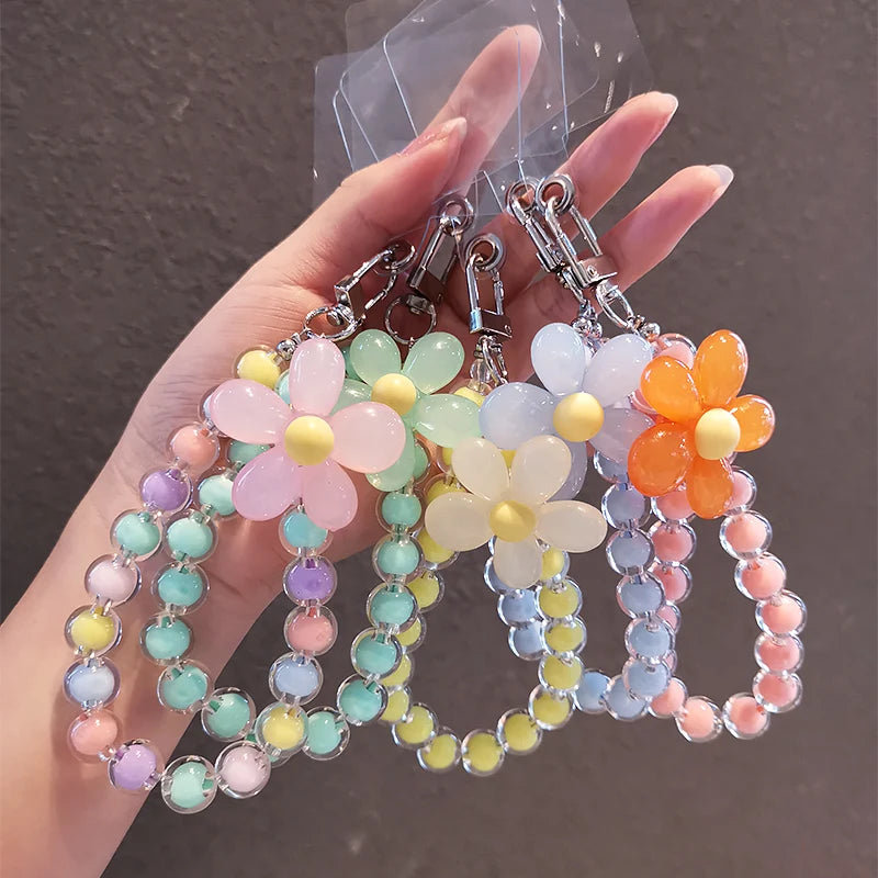 A hand holds a phone anti-loss lanyard featuring round beads in pastel colors like pink, yellow, green, and blue.