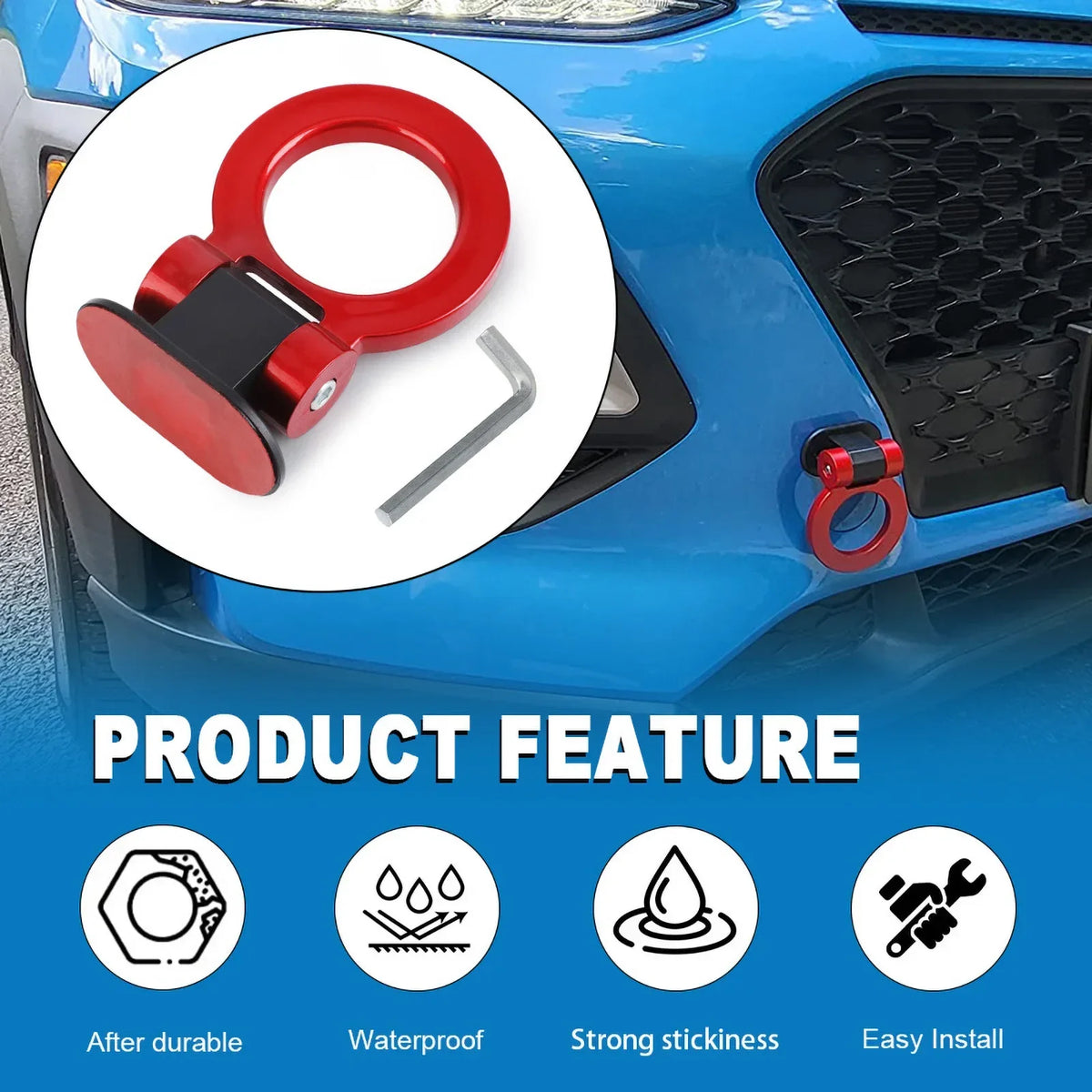 A close-up view of a red racing tow hook sticker being installed on a blue car bumper.