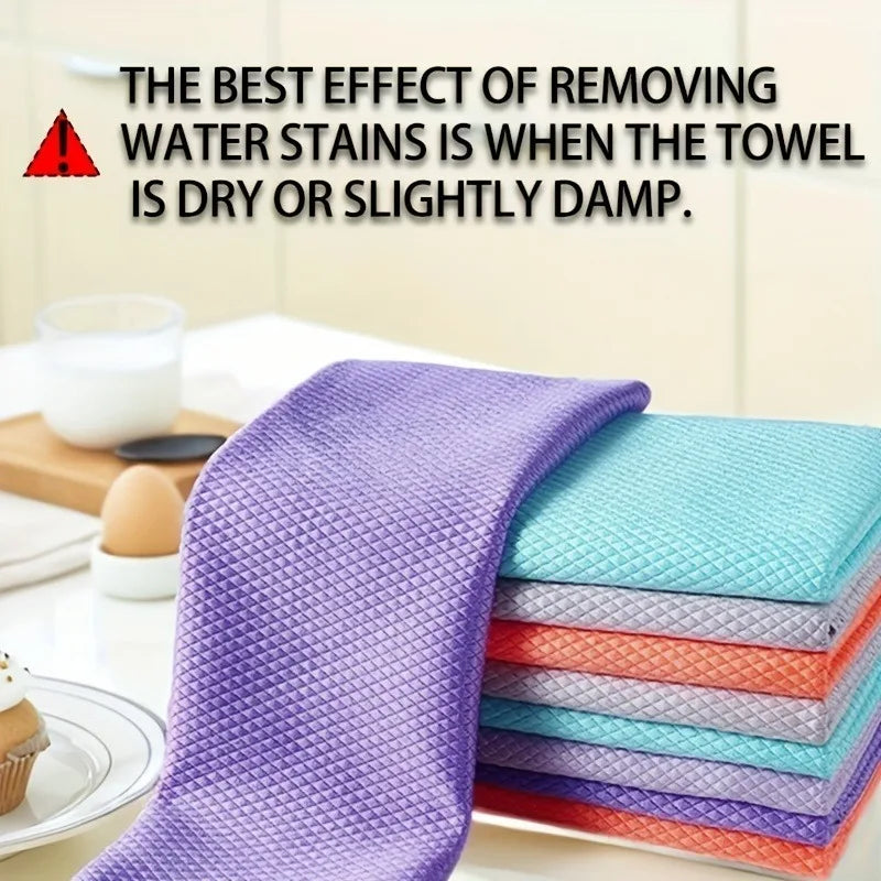 A stack of purple reusable glass cleaning cloths on a white surface.