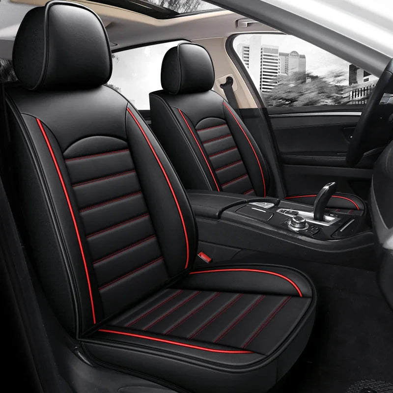 Interior view of a black car seat with red stitching and leather covers in a vehicle cabin.