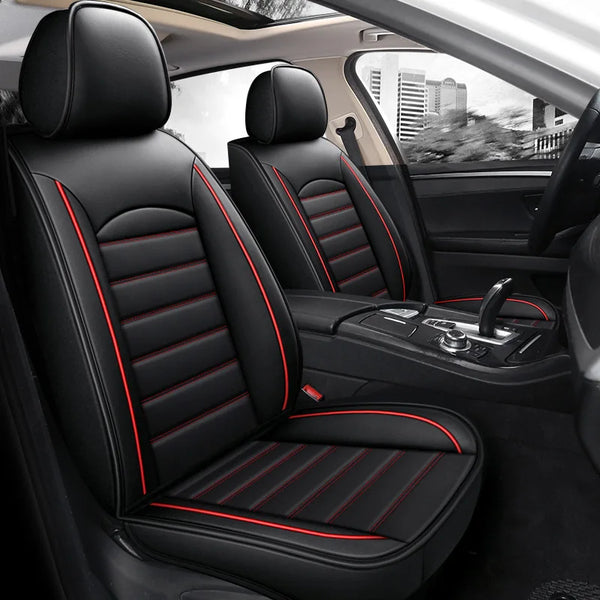 Interior view of a black car seat with red stitching and leather covers in a vehicle cabin.