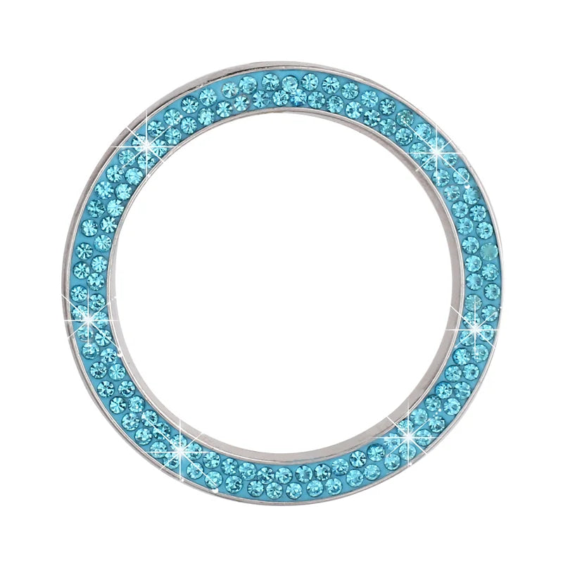 A circular cover decorated with blue rhinestones and silver metal, designed for a car start button.