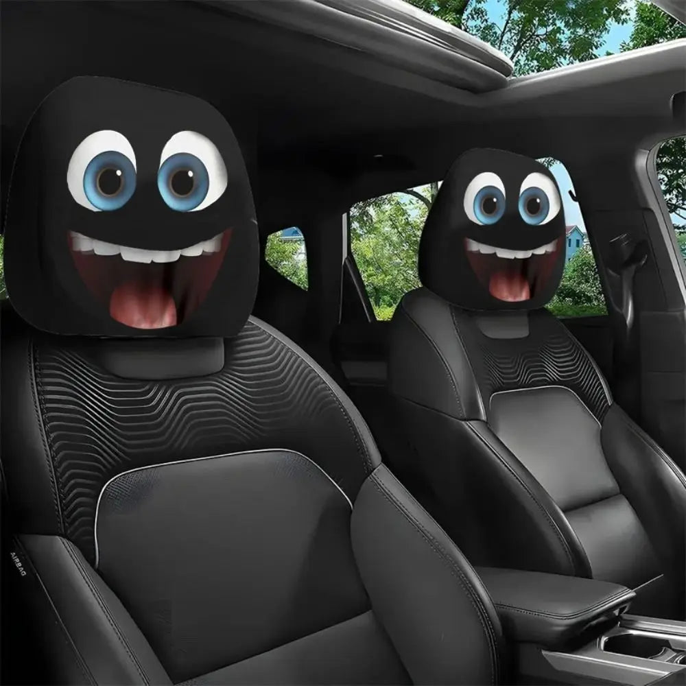 Black car seat headrest covers featuring decorative, cartoonish eyes and smiles.
