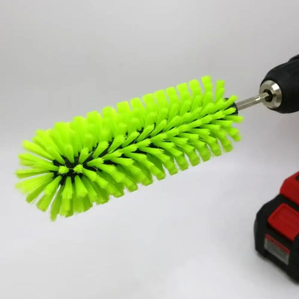 A bright lime green drill brush with numerous stiff bristles is shown attached to a drill or tool.