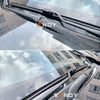 Close-up view of a windshield wiper blade assembly on a vehicle, showing the blade and mounting mechanism.