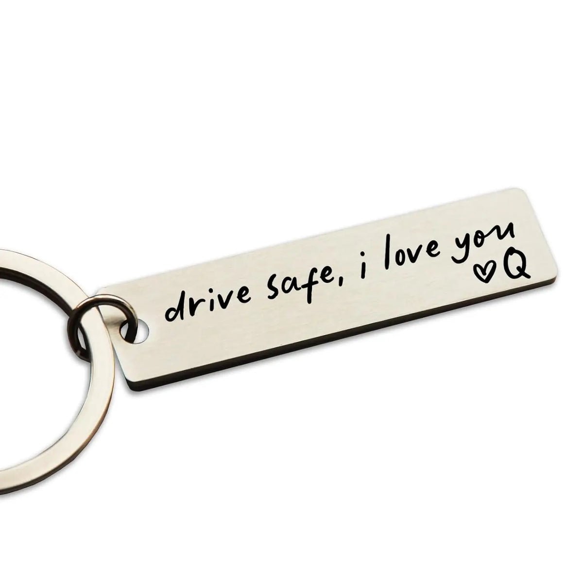 A rectangular stainless steel keychain engraved with the message drive safe i love you and a heart symbol