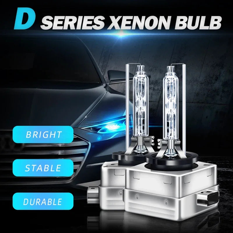 A set of D Series Xenon bulbs displayed in holders on a dark surface with a blurred car headlight background.