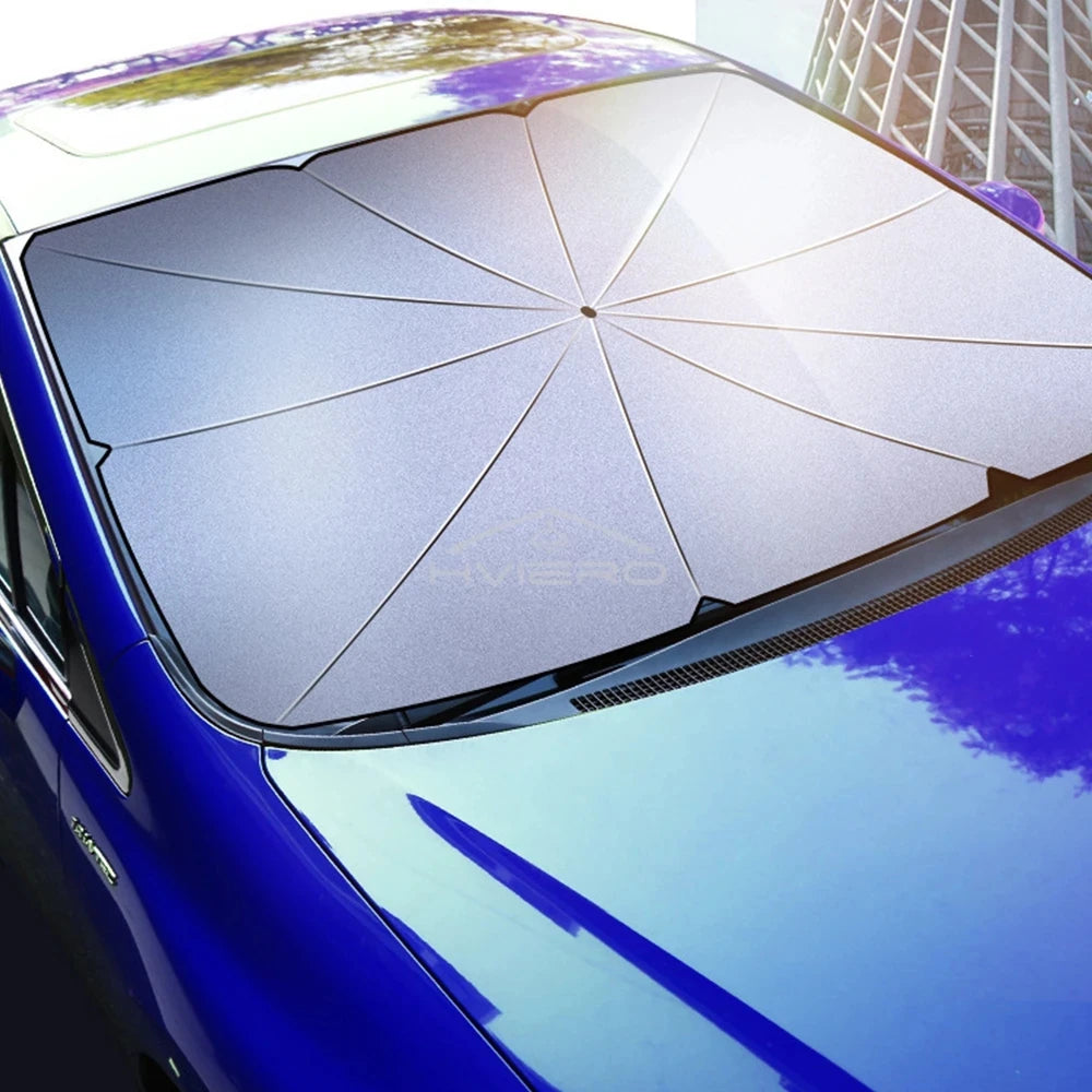A close-up view of a purple car with a deployed sun shade umbrella on the windshield.
