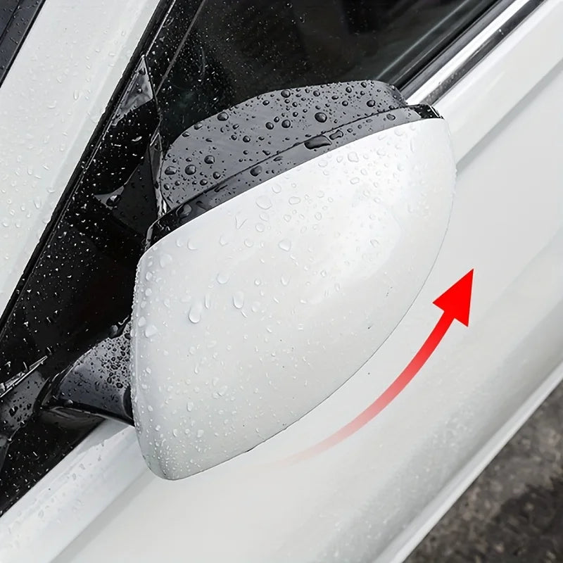 A close-up of a white car door featuring a dual blind spot mirror with a clear rain shield.