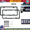 A set of two stainless steel license plate frames with mounting hardware for vehicle use.
