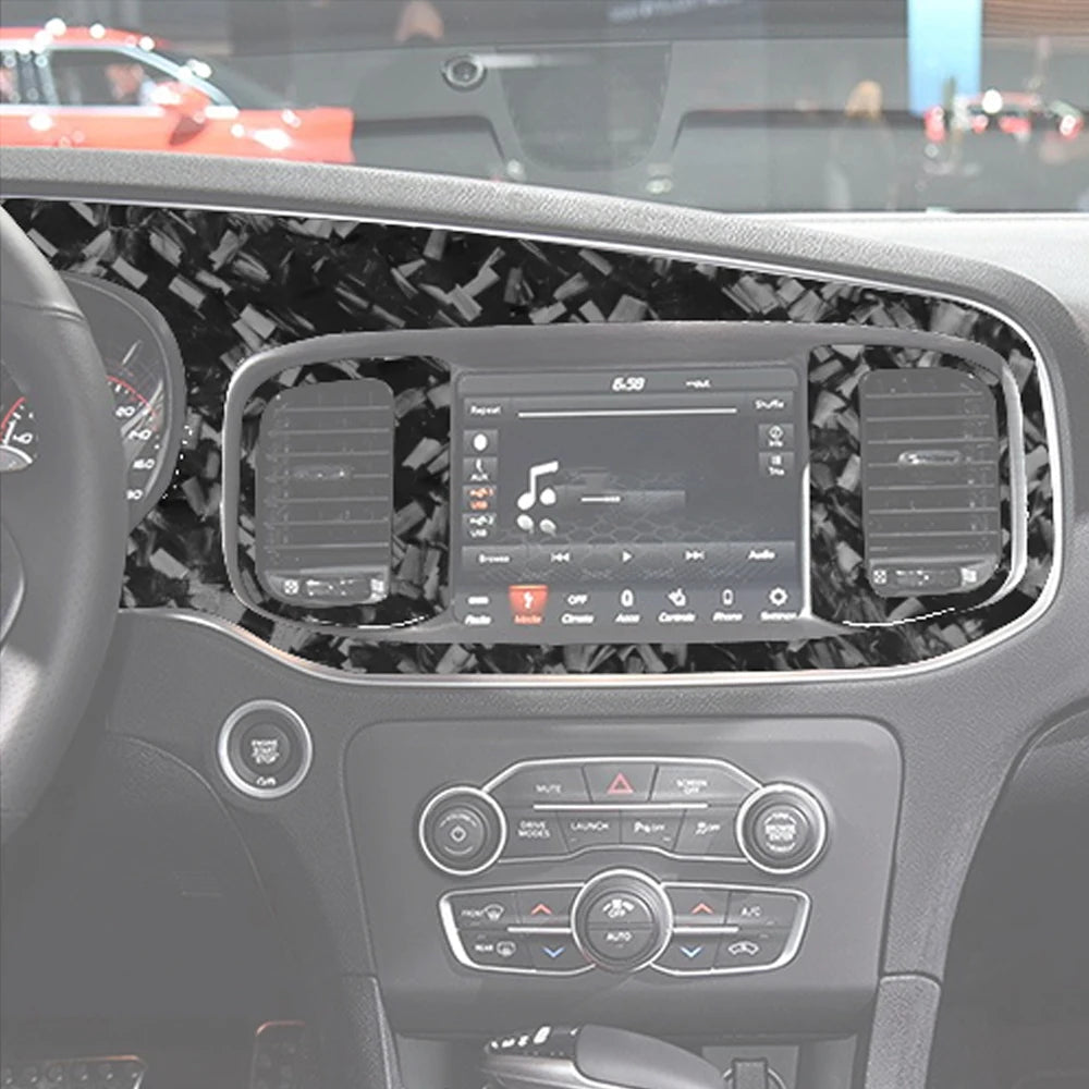 Vista interior del tablero de un coche mostrando adornos y controles de fibra de carbono forjada.