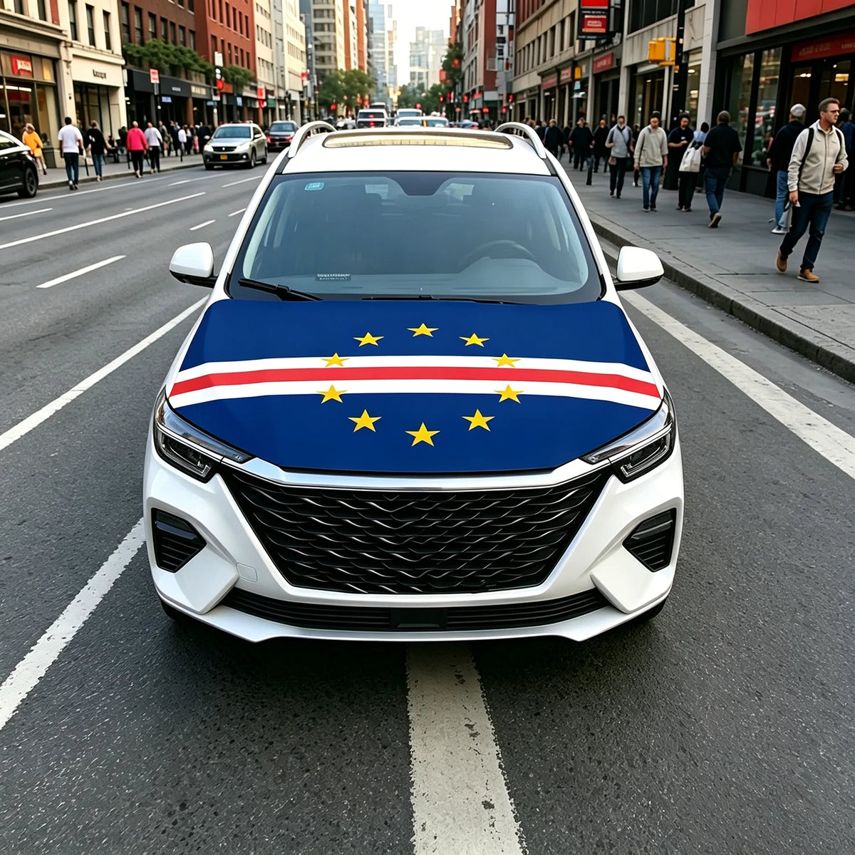A white car with a blue and yellow European flag design on the hood driving on a city street.