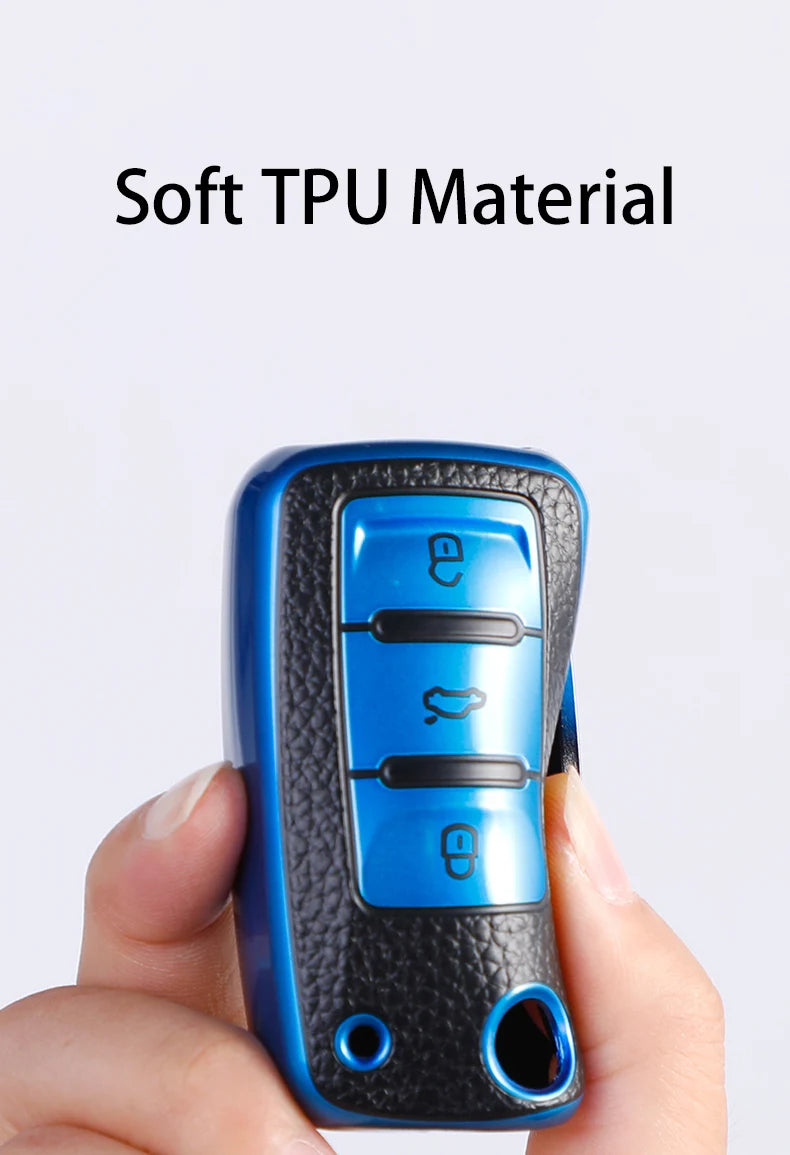 A hand holds a blue TPU material car key fob cover for Volkswagen Group vehicles.
