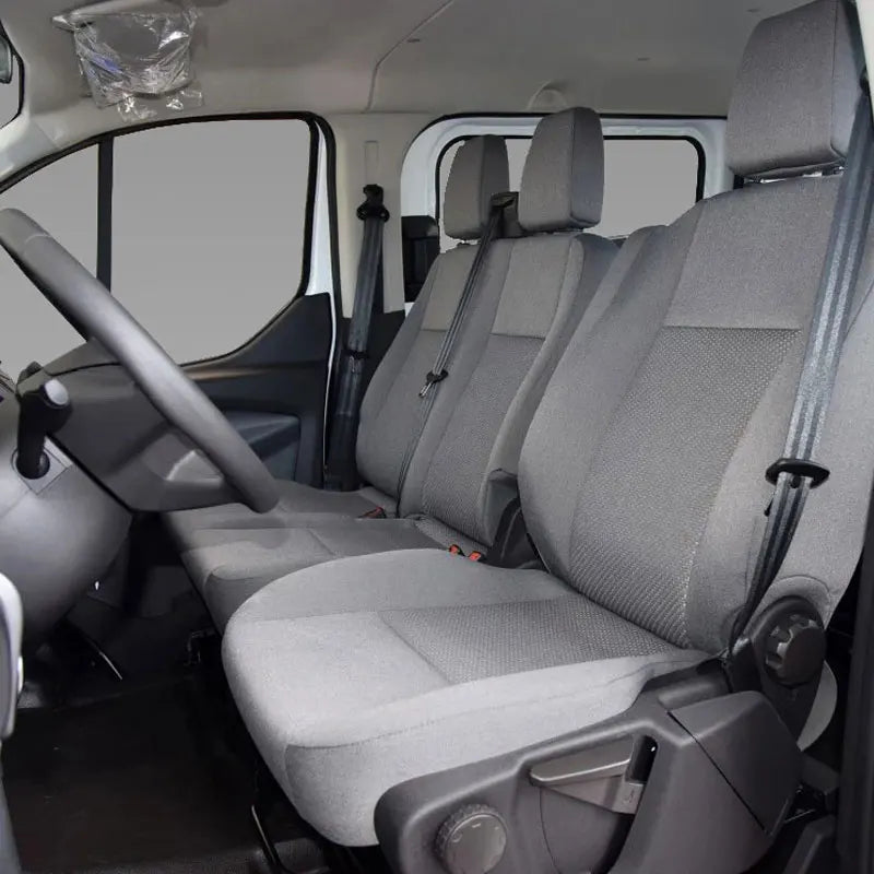 Gray seat covers installed on the front seats of a van or truck interior.