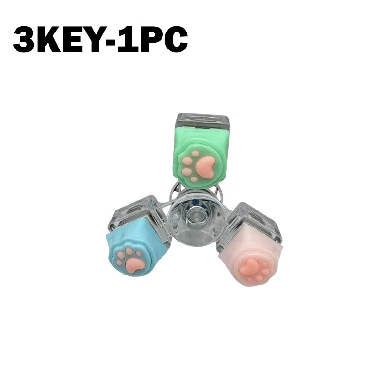 A set of three silicone paw-shaped fidget toys attached to a keychain, used for stress relief.