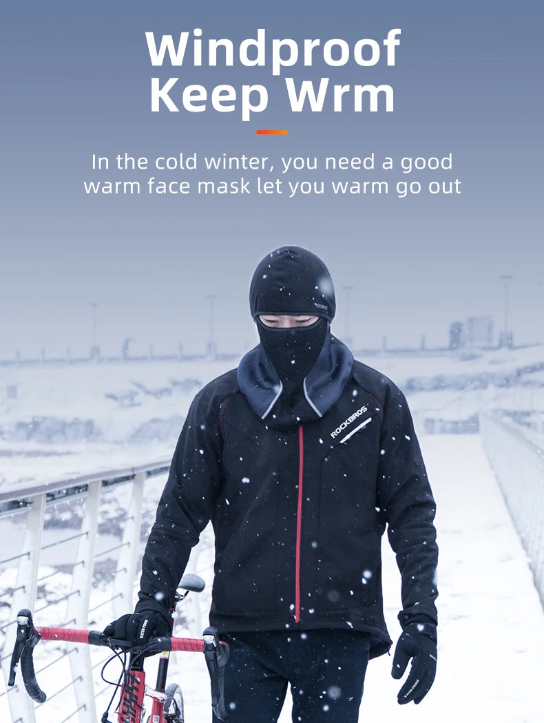 A person wearing a black windproof face mask and jacket is cycling in the snow.