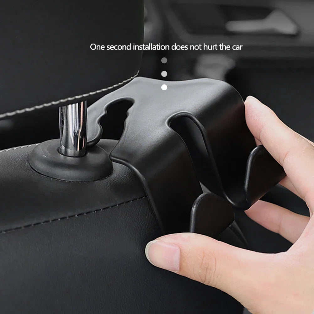 A hand installs a car seat headrest hook into a black car seat, demonstrating easy installation.