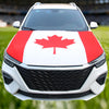A white car hood decorated with a red maple leaf flag design.
