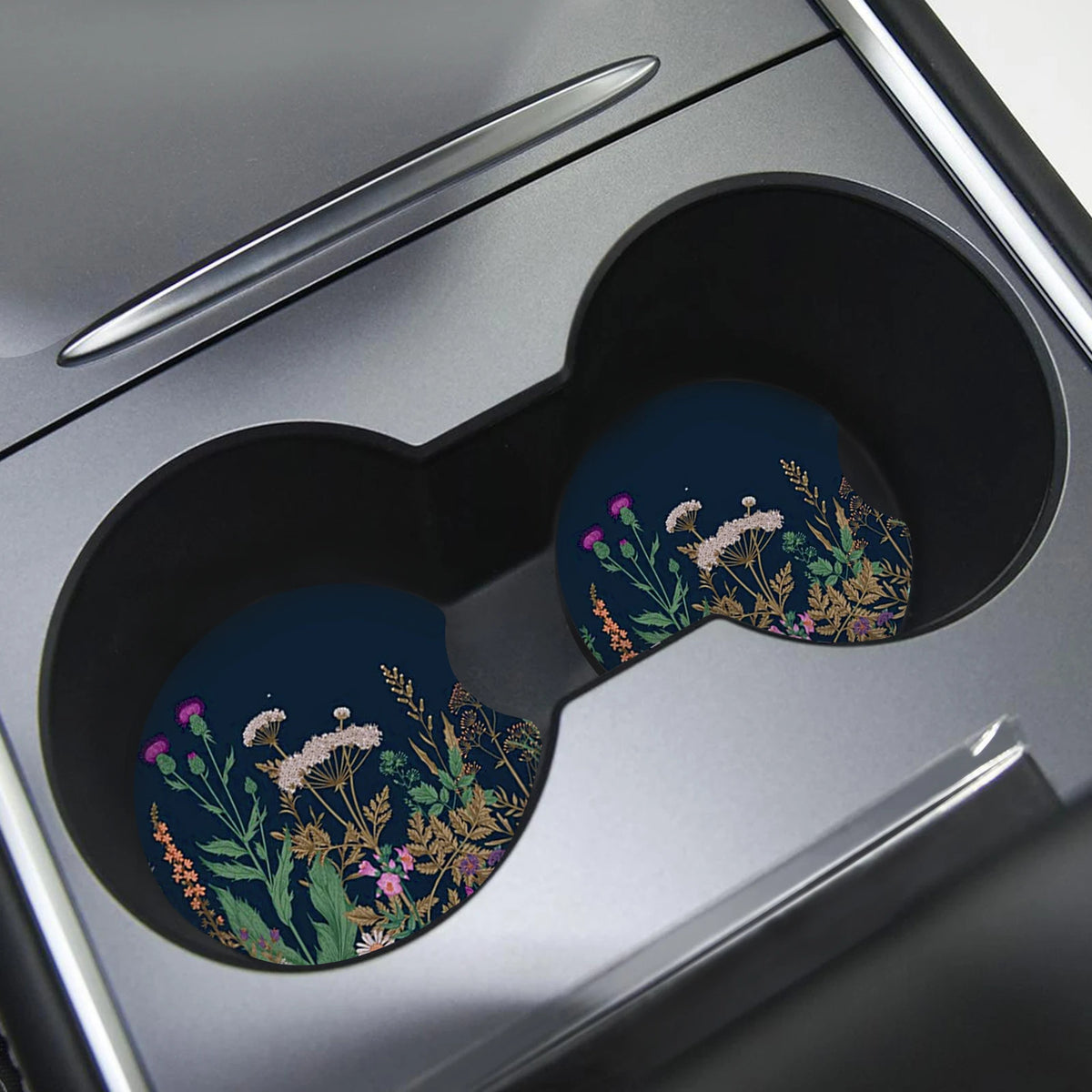 A close-up of a coaster with a floral pattern featuring purple and yellow flowers on a dark blue background.