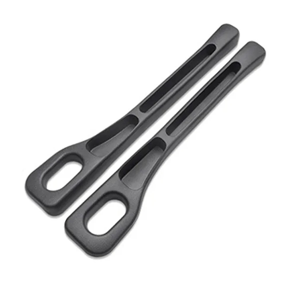 A pair of black universal car seat gap filler strips.