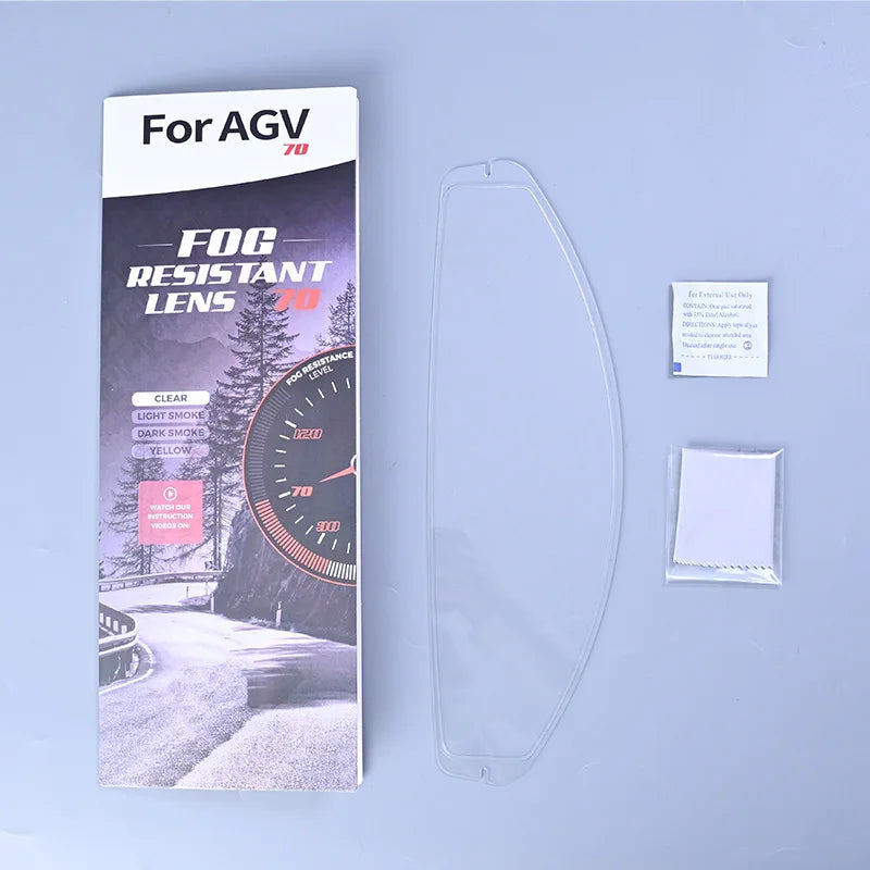 A package for a fog resistant lens for an AGV 70 motorcycle helmet visor is shown next to a clear plastic lens and a white le