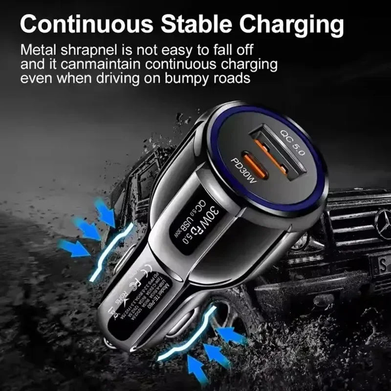 A close-up of a black car charger with dual USB ports and PD/QC capabilities being used on a rough road surface.