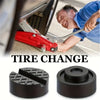 A close-up of a red tire changing tool and rubber jack pad for frame rail protection.
