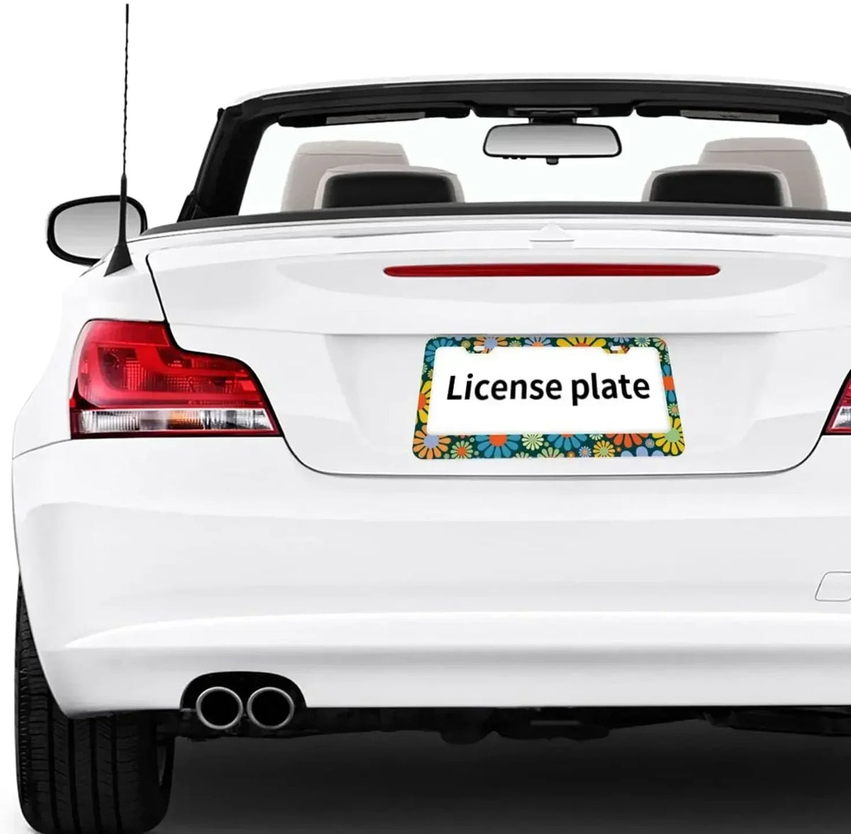 A white car's rear view showing a license plate frame with colorful floral design.