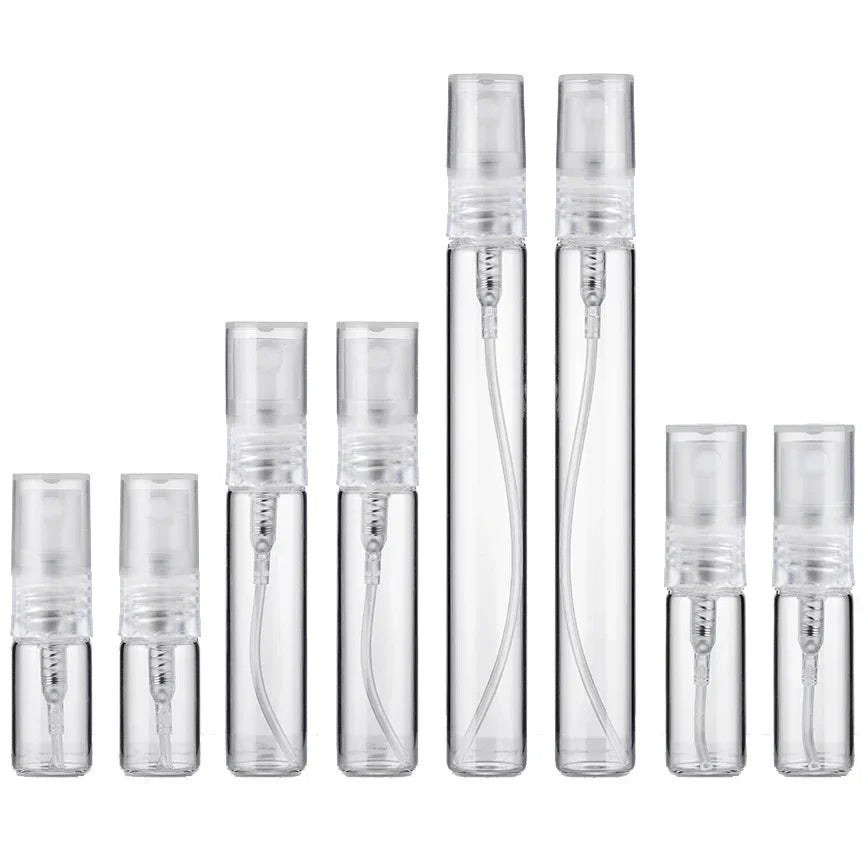 A set of six clear glass perfume bottles with silver caps and glass droppers.