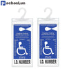 A transparent license plate holder with a hanging strap displaying a disabled parking identification permit.