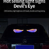 A close-up of a black car's front grille with an RGB dynamic demon eye light display activated.