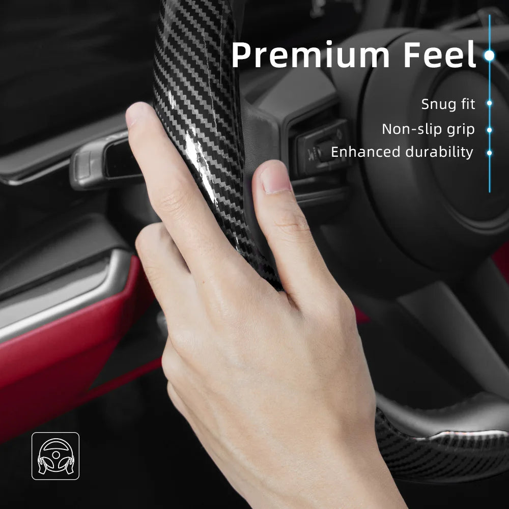 A hand grips a carbon fiber texture steering wheel cover, highlighting its premium feel and durability.