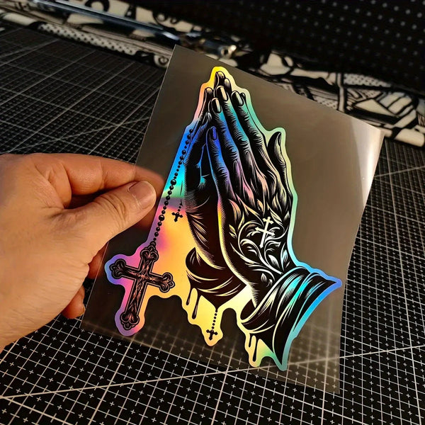A glossy decal featuring a silhouette of praying hands with crosses and a rainbow gradient effect.