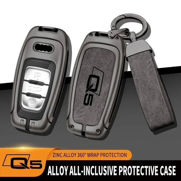 A protective case for an Audi Q5 key fob made of zinc alloy with a lanyard attached.