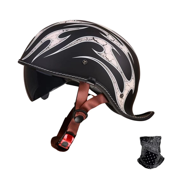 A black and white vintage style motorcycle helmet with brown leather straps shown from the side.