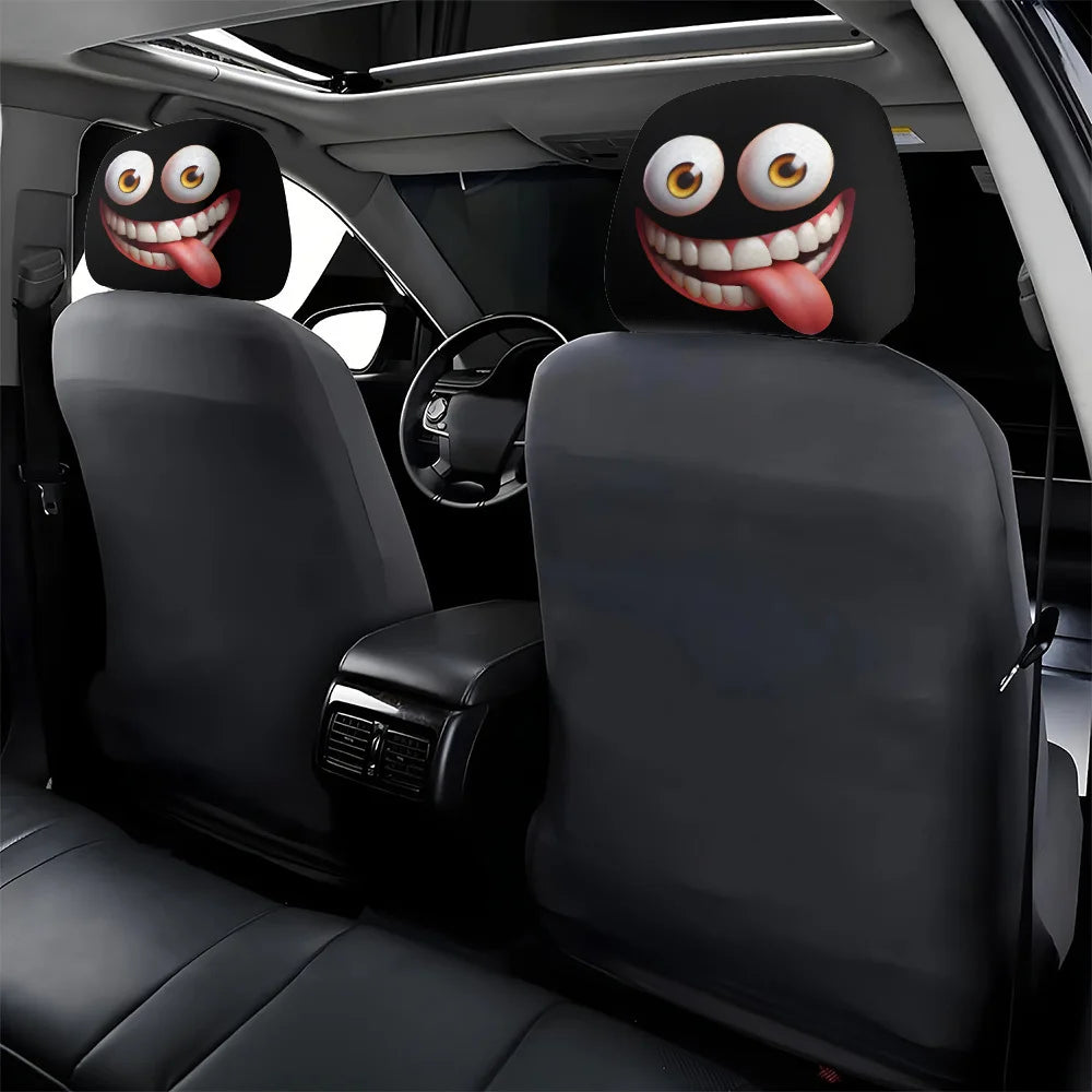 A set of two funny cartoon car headrest covers with big eyes and tongue-out designs installed in a vehicle interior.