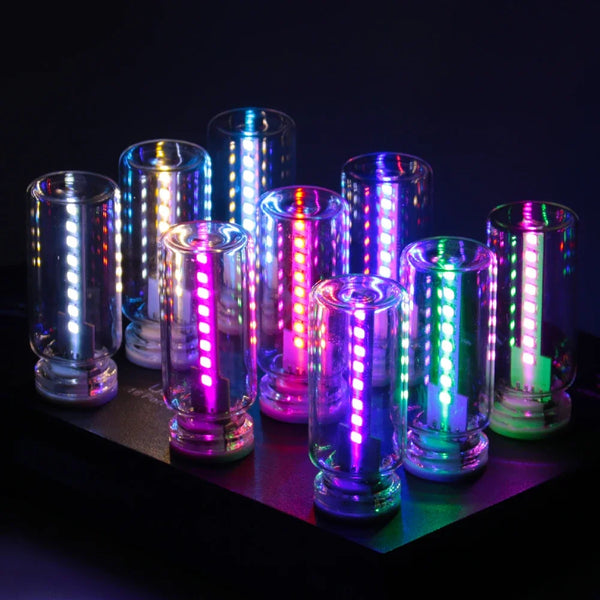 A collection of glowing LED tubes and cylindrical lights displaying various colors on a dark surface.