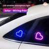 A white car window features a glowing blue heart light, demonstrating a solar wiring-free LED window atmosphere light.