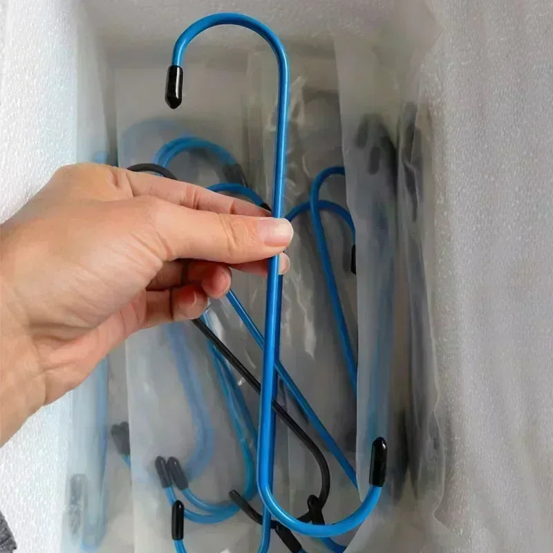 A hand is holding a blue car brake caliper hanger, which is used to hang brake calipers for axle and suspension.