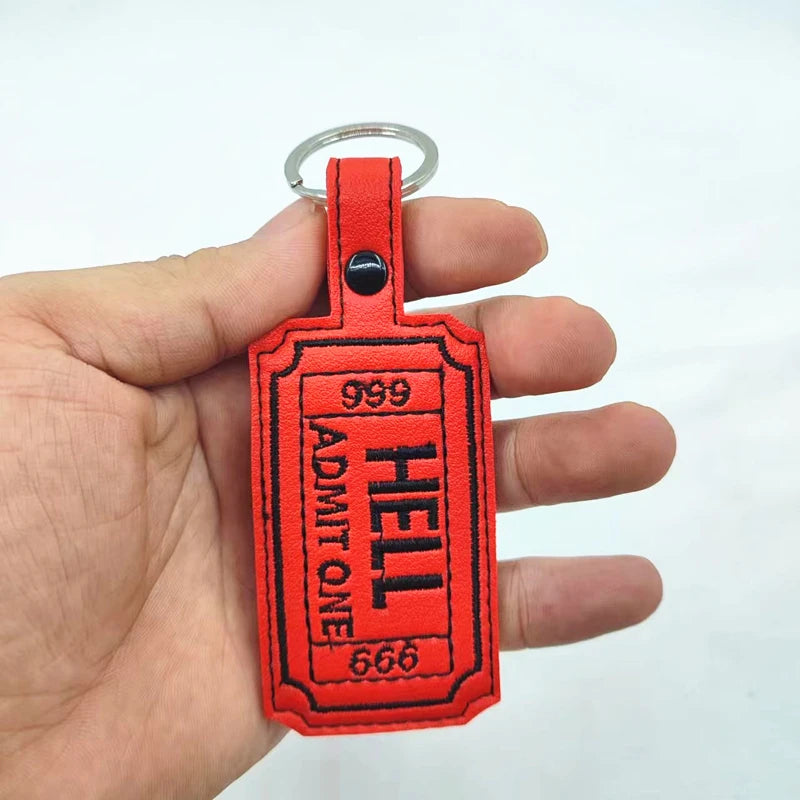 Red gothic keyfob luggage tag with black lettering and a silver ring attached