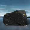 Black motorcycle cover with night reflective strips shown on a dark surface under rain.