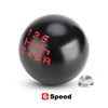 A black aluminum gear shift knob with red markings showing 135, 246, and R, next to a silver washer.