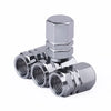 A set of four shiny silver hex aluminum alloy tire valve caps stacked together.