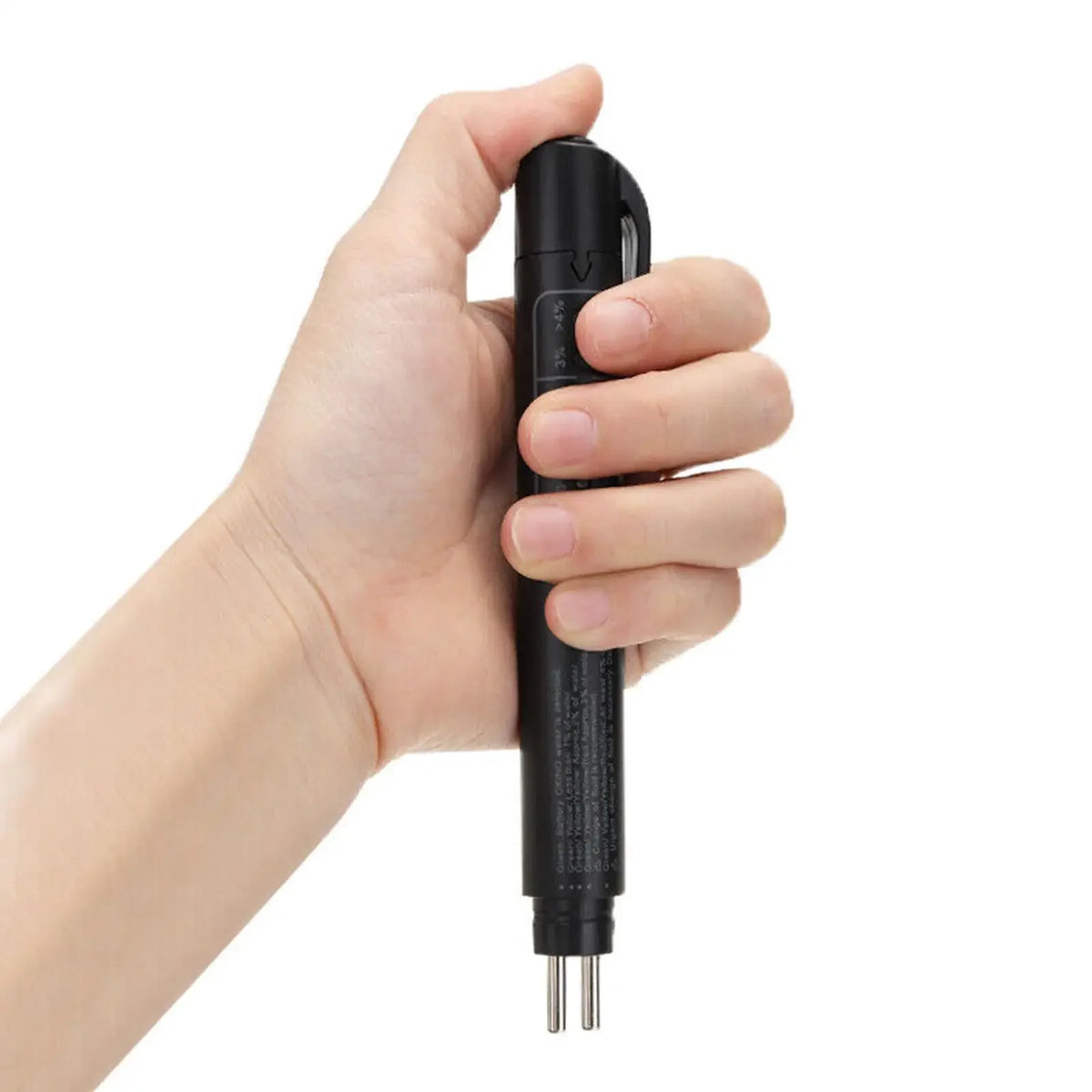 A hand is holding a black brake fluid quality tester with a connector plug.