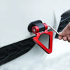 A hand is installing a red and black racing style car tow hook onto a white vehicle's body panel.