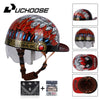 A black motorcycle helmet with a red and silver leaf design, shown next to accessories like sunglasses and a leather pouch.