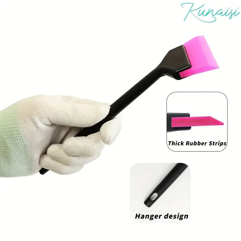 A hand is holding a black tool with a pink rubber strip for car window film installation.
