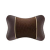 A brown universal car headrest pillow with a textured fabric cover.